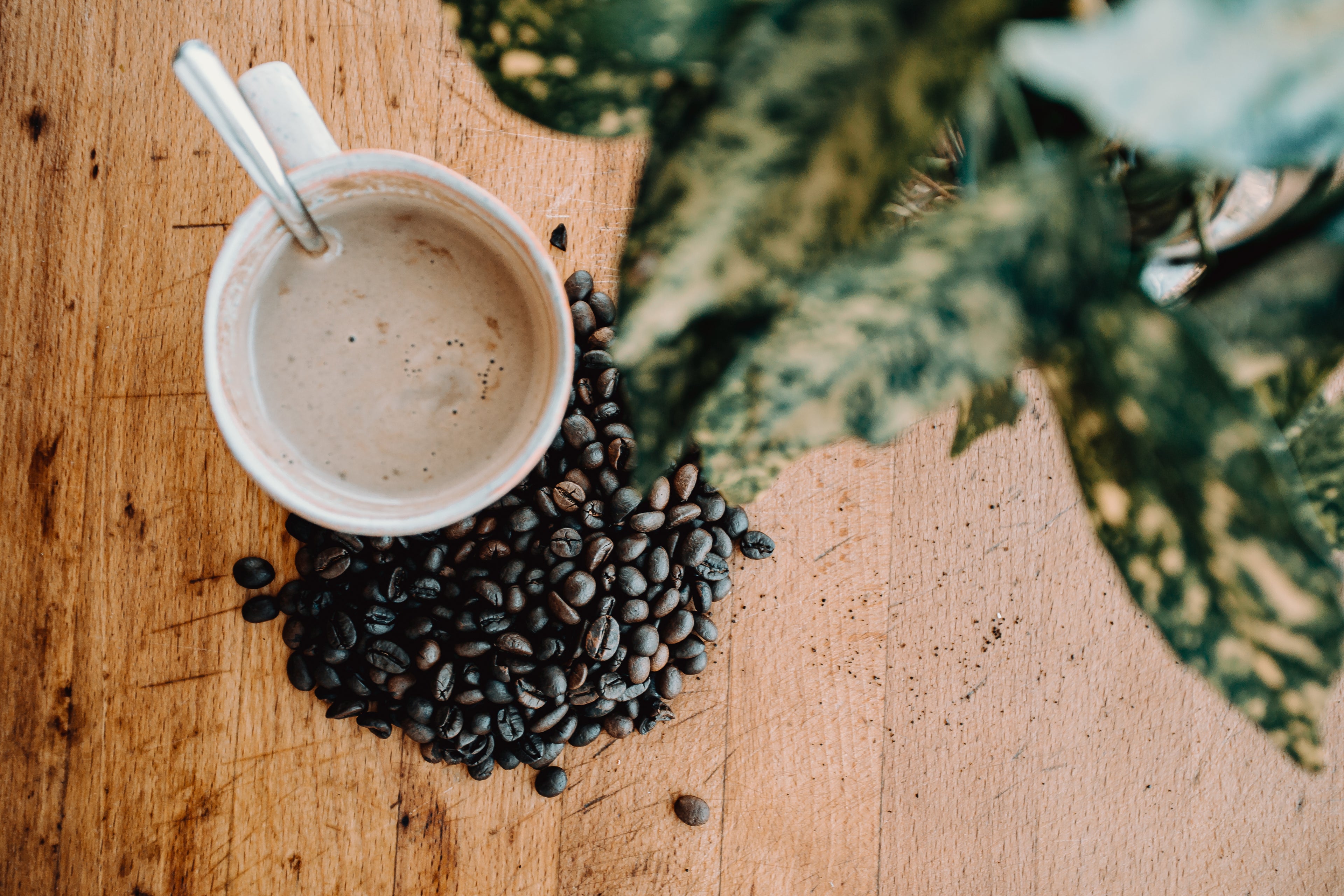 coffee cup and beans on table
